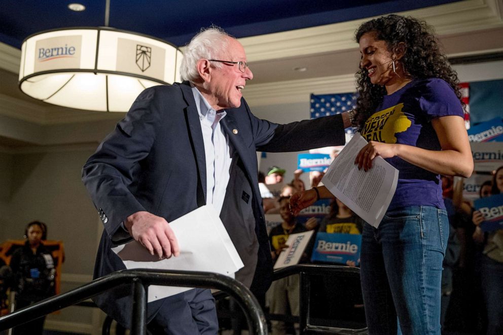 PHOTO: Democratic presidential candidate Sen. Bernie Sanders is welcomed to the stage by Sunrise Movement co-founder Varshini Prakash, right, at the Graduate Hotel, Jan. 12, 2020, in Iowa City, Iowa.