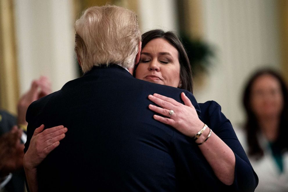 PHOTO: White House press secretary Sarah Sanders hugs President Donald Trump after announcing she will be leaving her position during an event in the East Room of the White House, June 13, 2019.
