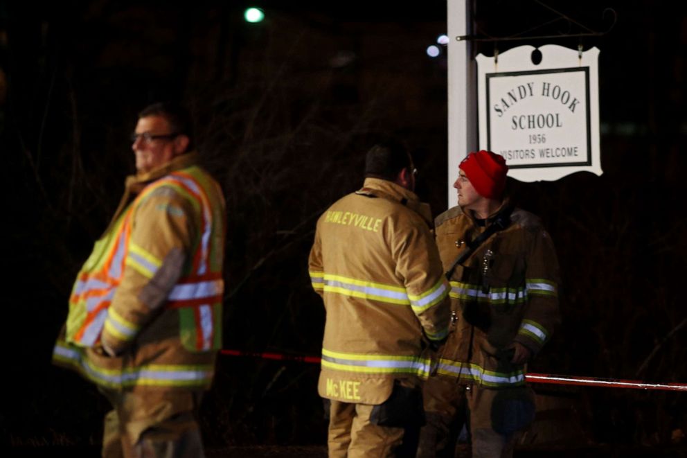 PHOTO: Emergency workers stand in front of the Sandy Hook School, Dec. 14, 2012, in Newtown, Conn. Twenty-seven are dead, including 20 children, after a gunman identified as Adam Lanza in news reports, opened fire in the school.