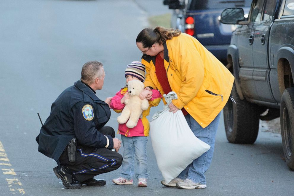 PHOTO: A child and her mother leave staging area outside Sandy Hook Elementary School in Newtown, Conn., Dec. 14, 2012.
