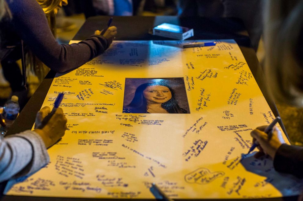 PHOTO: Mourners leave messages on a poster at a vigil held for shooting victims, Nov. 17, 2019, in Santa Clarita, California.