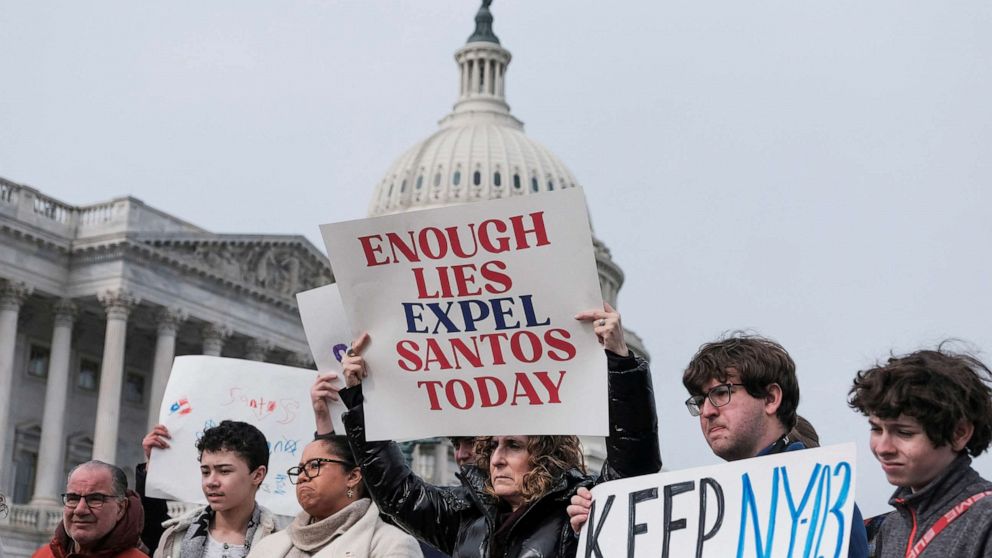 PHOTO: People hold banners on the day of a news conference calling for the resignation of Santos held by Rep. Dan Goldman, Rep. Ritchie Torres, and a group of Rep. George Santos's constituents at the Capitol, Feb. 7, 2023.