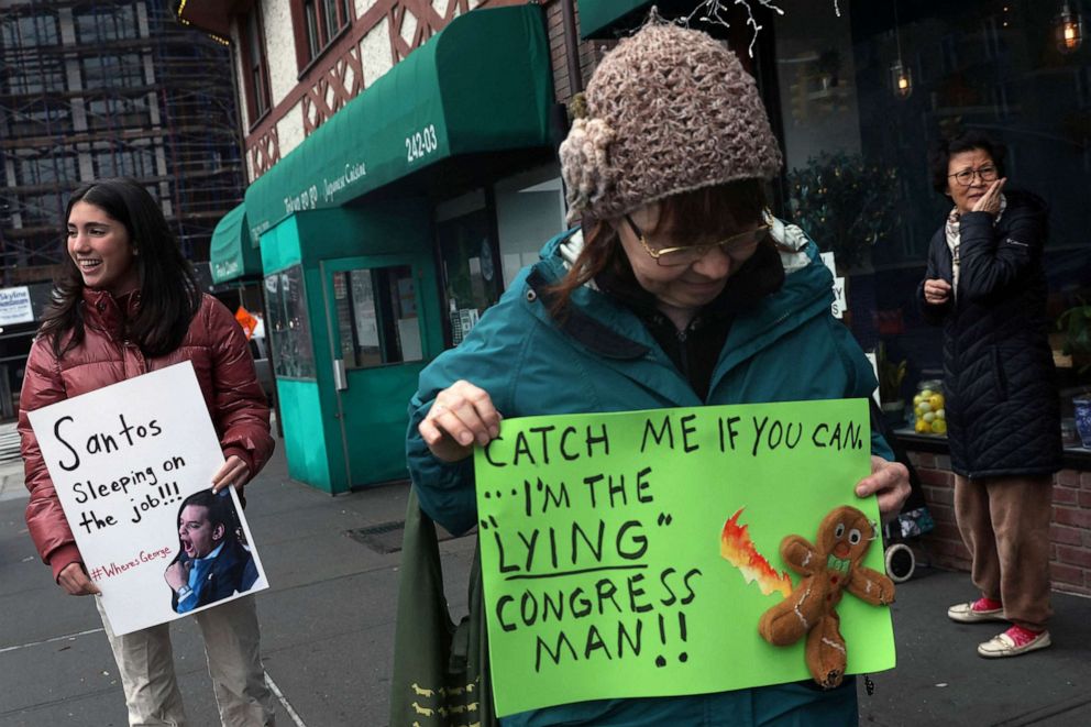 PHOTO: Marion Karp,17, holds a sign with others during a rally against newly elected freshman Rep. George Santos who is facing a scandal over his resume and claims he made on the campaign trail in New York City, Jan. 13, 2023.