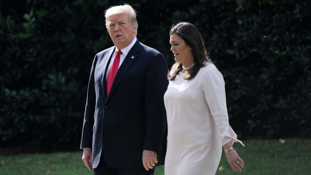 PHOTO: President Donald Trump walks with White House Press Secretary Sarah Huckabee Sanders as they leave the White House to board Marine One, Oct. 9, 2018, in Washington.