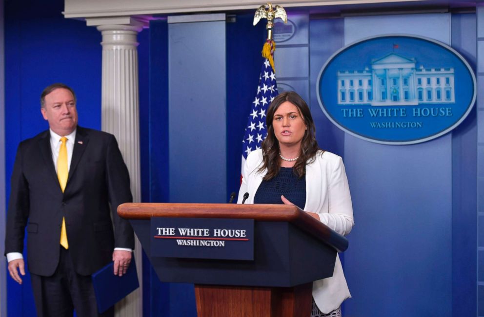 PHOTO: Secretary of State Mike Pompeo looks on as Press Secretary Sarah Huckabee Sanders speaks in the press briefing room at the White House in Washington, DC, June 7, 2018.