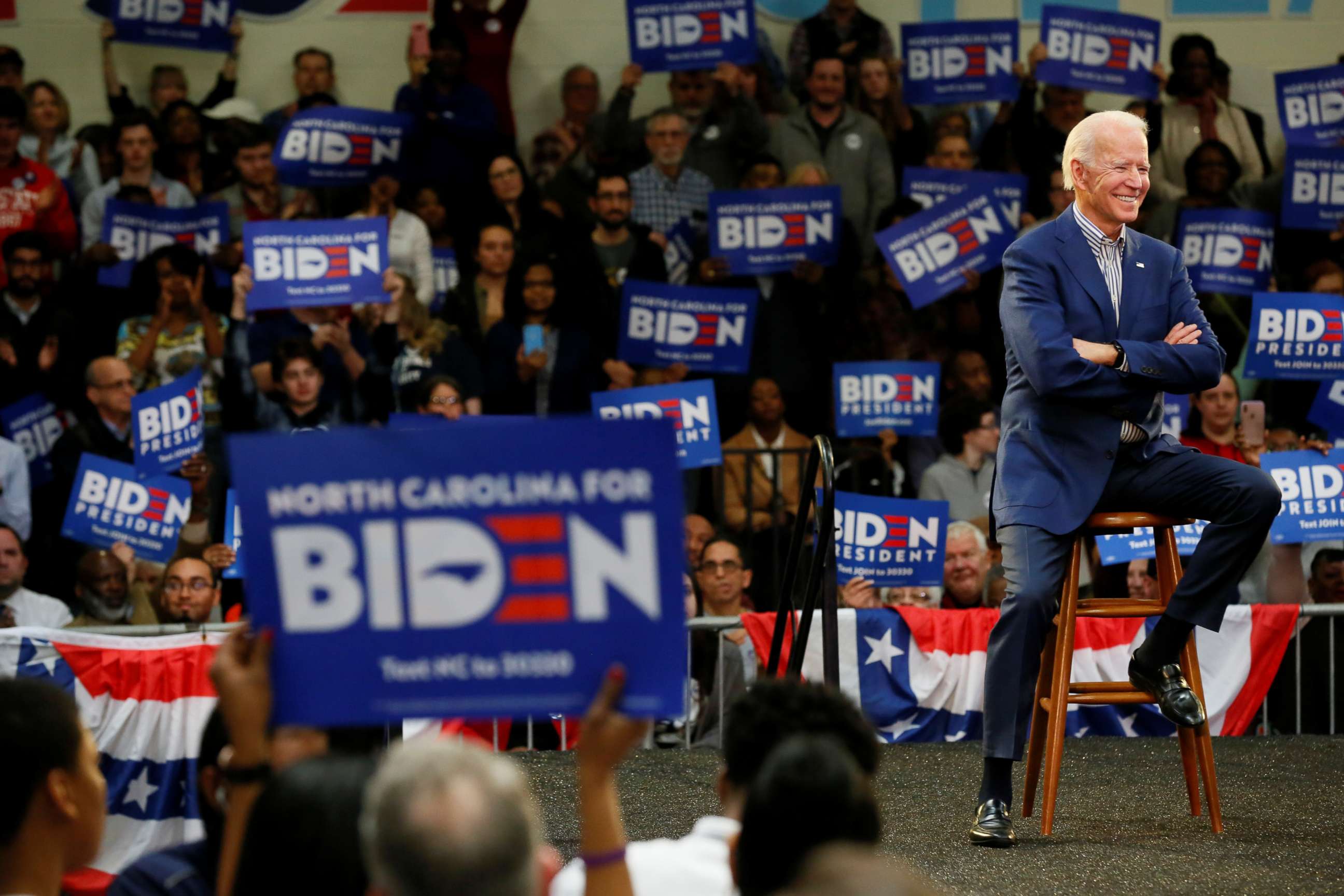 PHOTO: Democratic presidential candidate Joe Biden listens to the introductory speakers during a campaign event at Saint Augustine's University in Raleigh, N.C., Feb. 29, 2020.