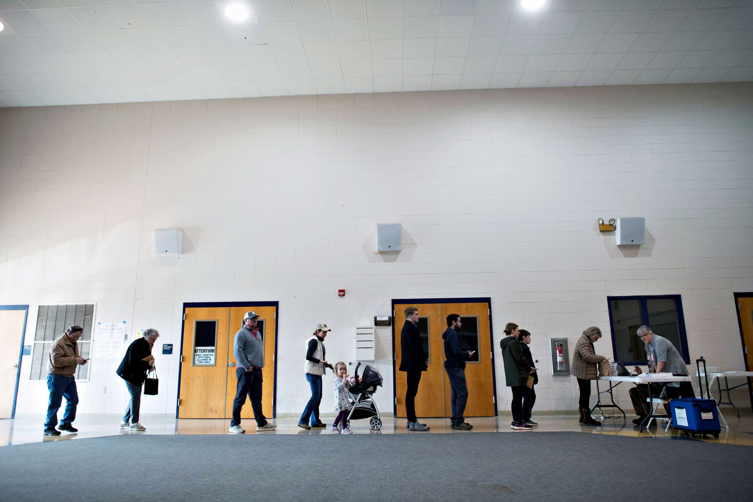PHOTO: Voters line up to register before casting their ballots at the Spartanburg High School polling location for the Democratic presidential primary in Spartanburg, S.C., Feb. 29, 2020.