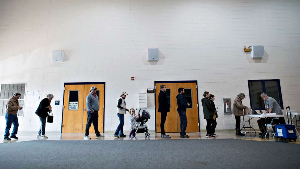 PHOTO: Voters line up to register before casting their ballots at the Spartanburg High School polling location for the Democratic presidential primary in Spartanburg, S.C., Feb. 29, 2020.