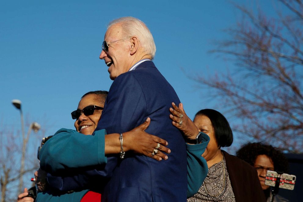 PHOTO: Democratic presidential candidate and former U.S. Vice President Joe Biden receives a hug from a supporter outside a polling site, in Greenville, S.C. on Feb. 29, 2020.