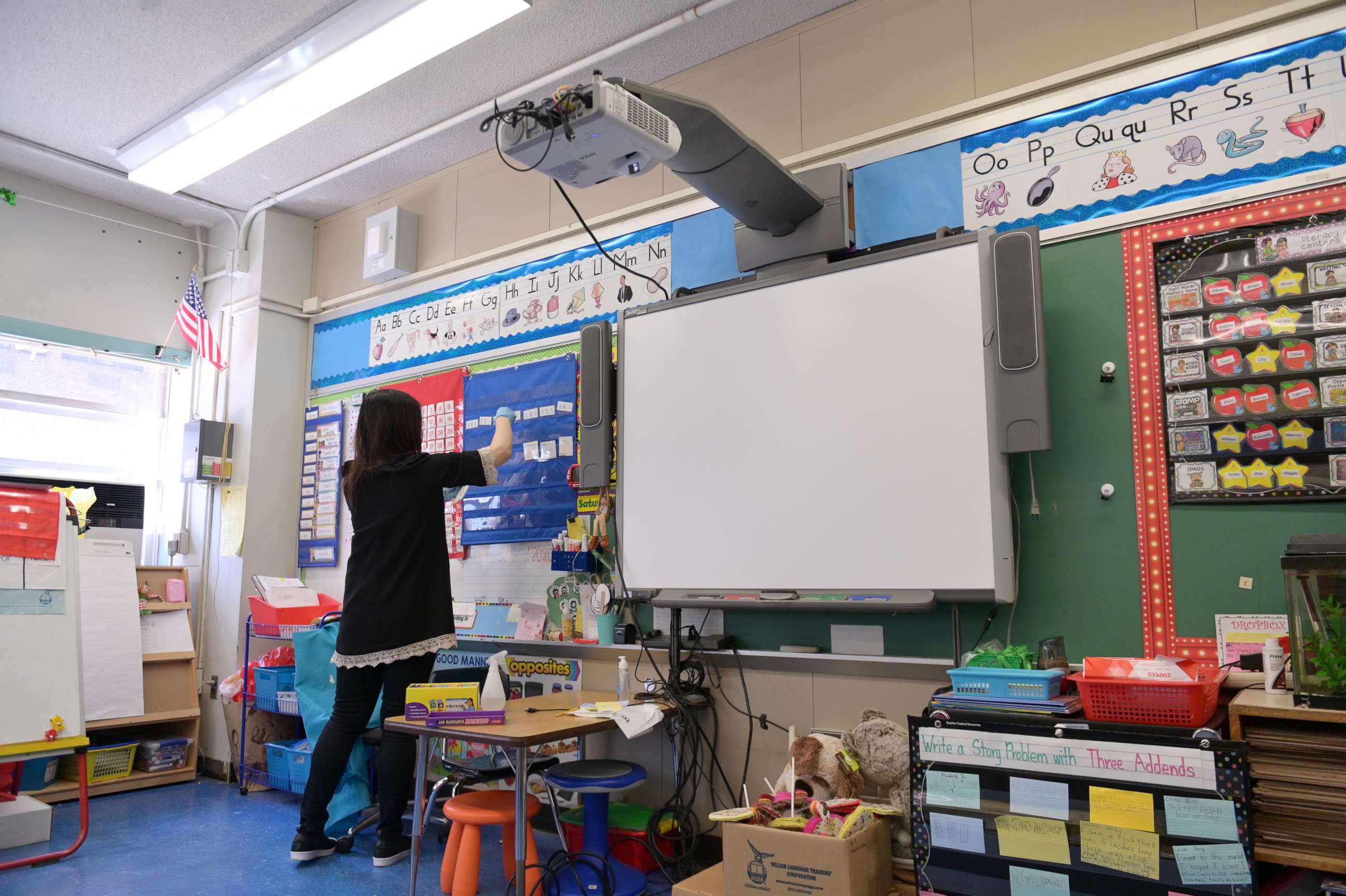 PHOTO: A teacher collects supplies needed to continue remote teaching through the end of the school year at Yung Wing School P.S. 124 on May 14, 2020 in New York City.