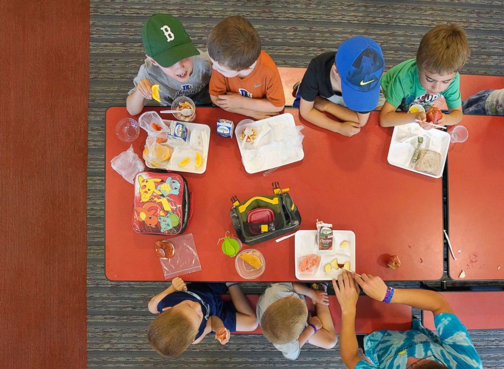 PHOTO: Children in a summer program eat lunch at a cafeteria in Buxton, Maine, July 12, 2018.