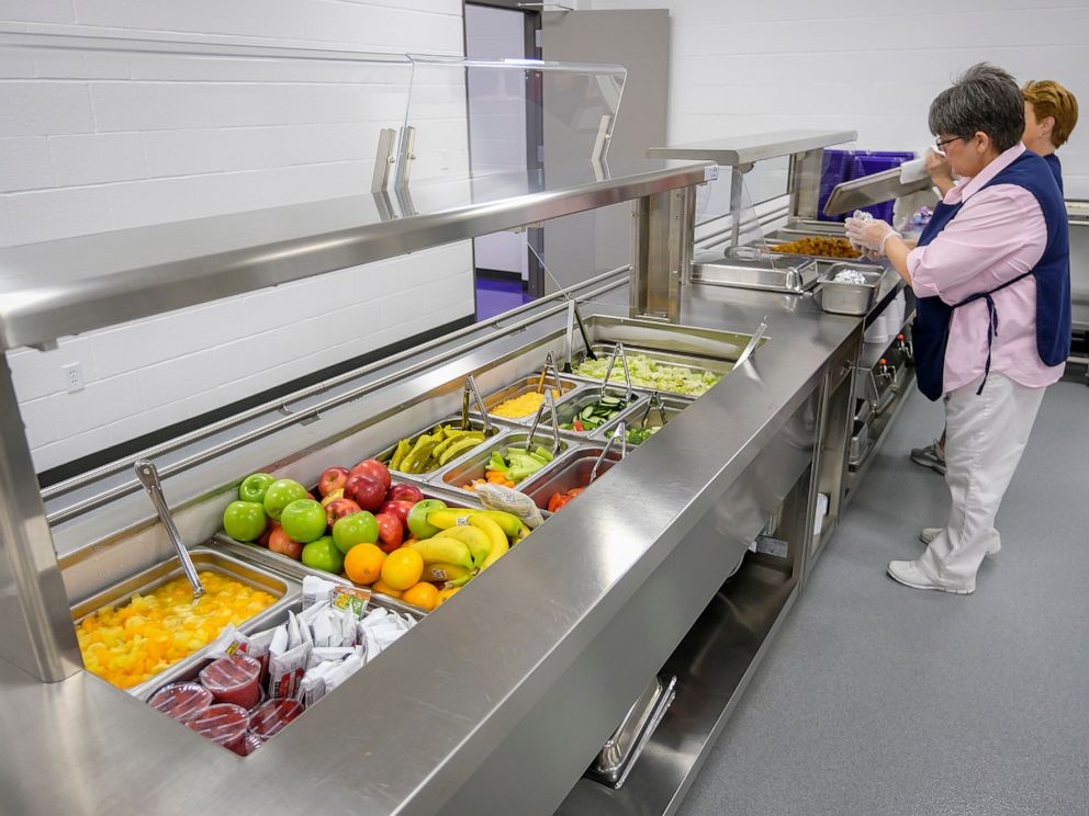 PHOTO: Michelle Hughes, head cook at Harrisburg High School, readies the serving line for lunch at the school on Feb. 14, 2019, in Harrisburg, Ill.