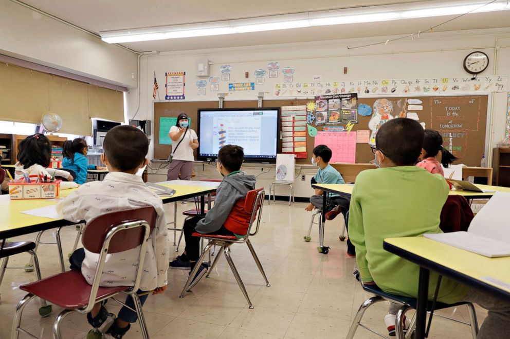 PHOTO: Melissa Wong, a teacher at Yung Wing School P.S. 124, gives a lesson to her masked students in their classroom on Sept. 27, 2021, in New York City.