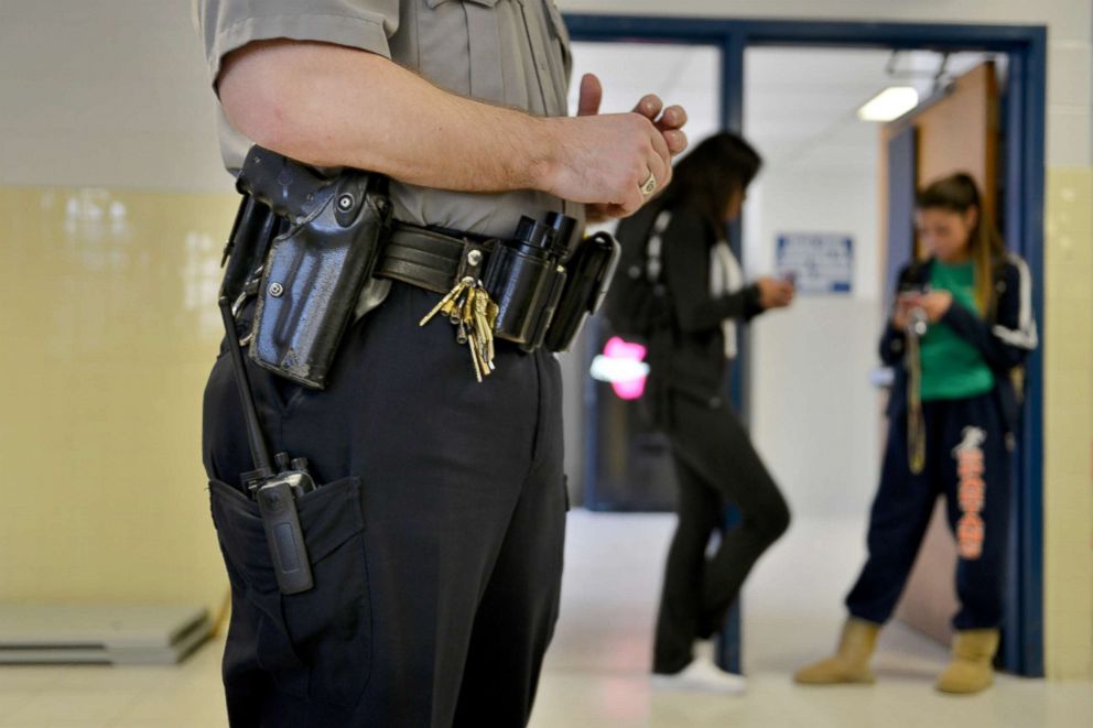 PHOTO: Officer Joe Plazio, of the Fairfax County Police Department, stays armed with his service pistol as he patrols the school where he is stationed at West Springfield High School, Jan. 18, 2012, in Springfield, VA.