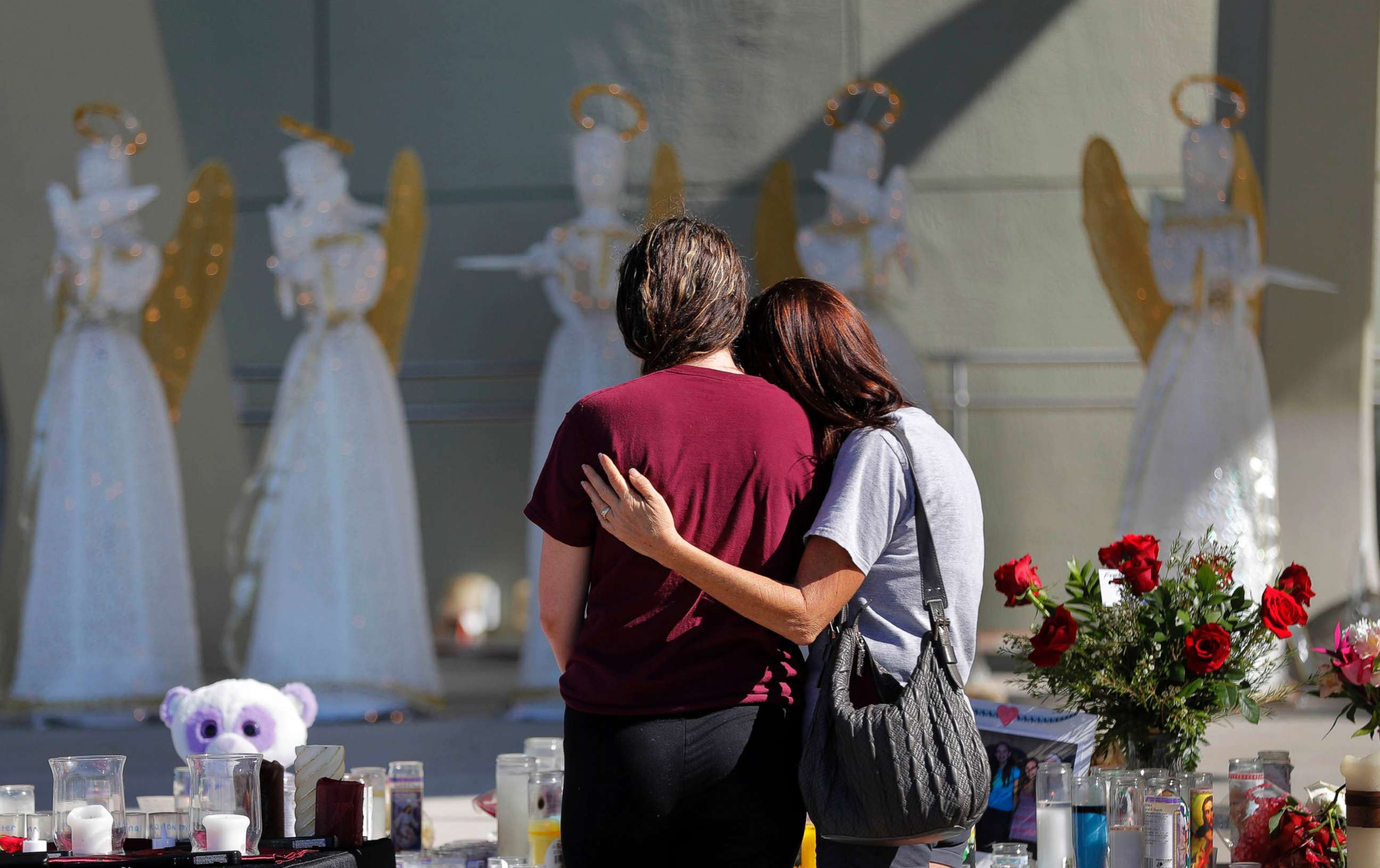 PHOTO: People comfort each other at a public memorial for the victims of the shooting at Marjory Stoneman Douglas High School, in Parkland, Fla., Feb. 16, 2018.