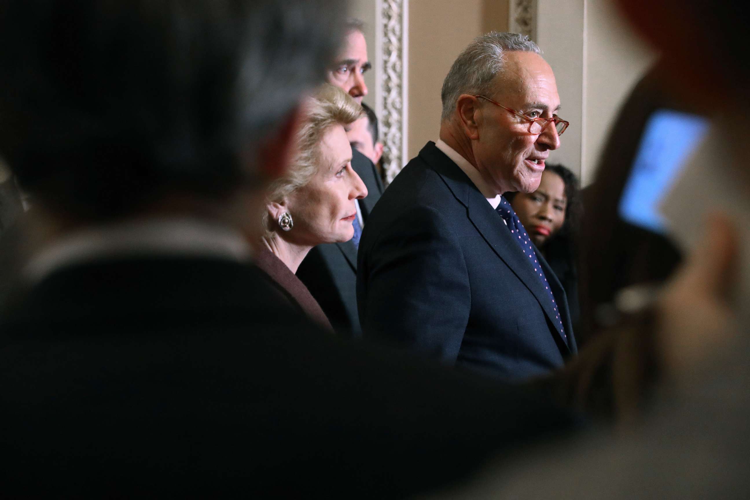 PHOTO: Senate Minority Leader Charles Schumer (D-NY) (C) talks to reporters following the weekly Senate Democratic policy luncheon at the Capitol, Jan. 7, 2020, in Washington, D.C.