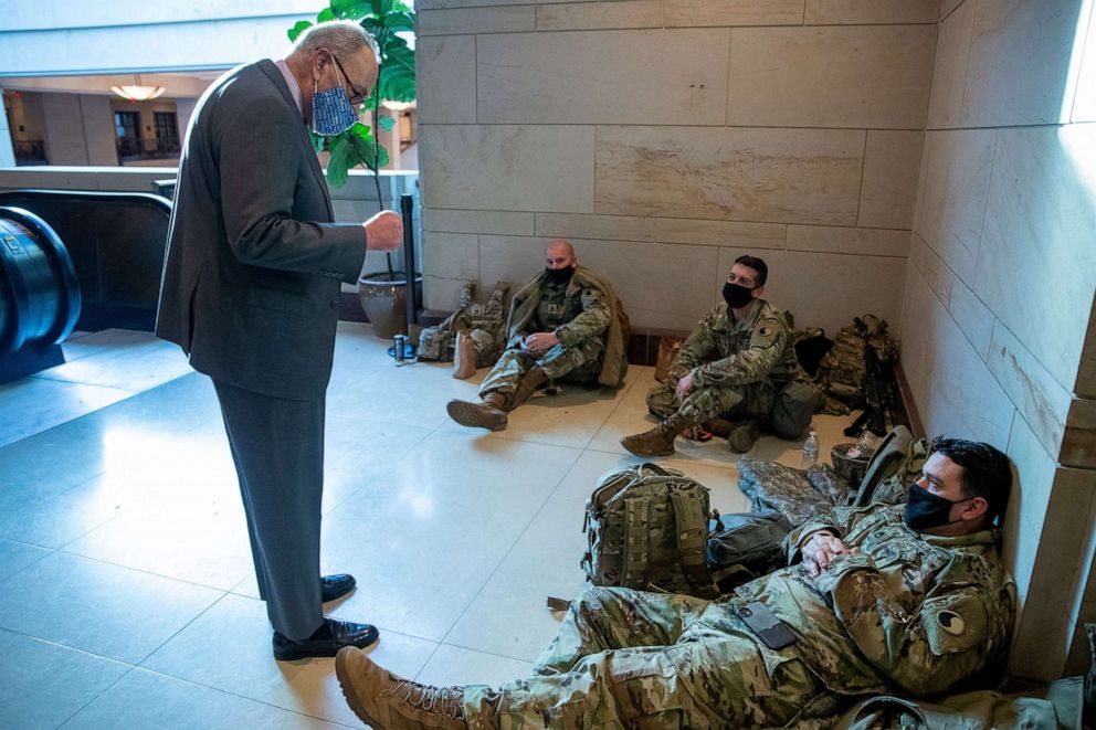 PHOTO: Senate Majority Leader Chuck Schumer greets National Guard soldiers inside the Capitol Visitors Center, Jan. 22, 2021, at the U.S. Capitol in Washington, D.C.