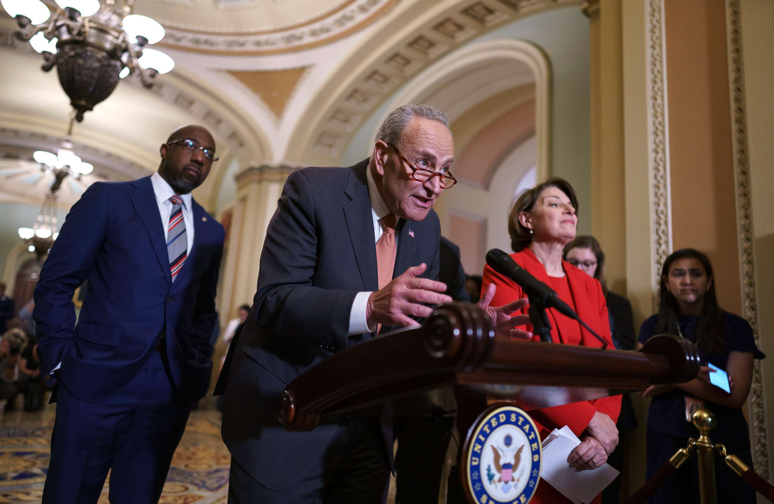 PHOTO: Senate Majority Leader Chuck Schumer, D-N.Y., flanked by Sen. Raphael Warnock, D-Ga., left, and Sen. Amy Klobuchar, D-Minn., speaks with reporters before a key test vote on the For the People Act on June 22, 2021. 