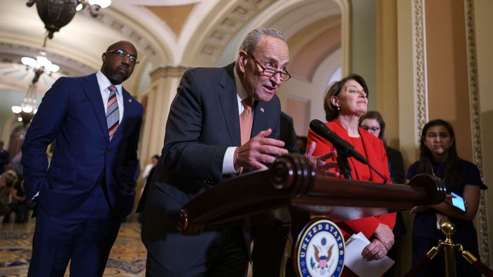 PHOTO: Senate Majority Leader Chuck Schumer, D-N.Y., flanked by Sen. Raphael Warnock, D-Ga., left, and Sen. Amy Klobuchar, D-Minn., speaks with reporters before a key test vote on the For the People Act on June 22, 2021. 
