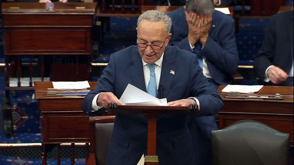PHOTO: Sen. Joe Manchin covers his face with his hands while Sen. Chuck Schumer talks about the debt limit on the floor of the Senate in Washington, Oct. 7, 2021.