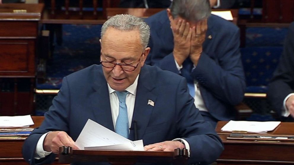 PHOTO: Sen. Joe Manchin covers his face with his hands while Sen. Chuck Schumer talks about the debt limit on the floor of the Senate in Washington, Oct. 7, 2021.