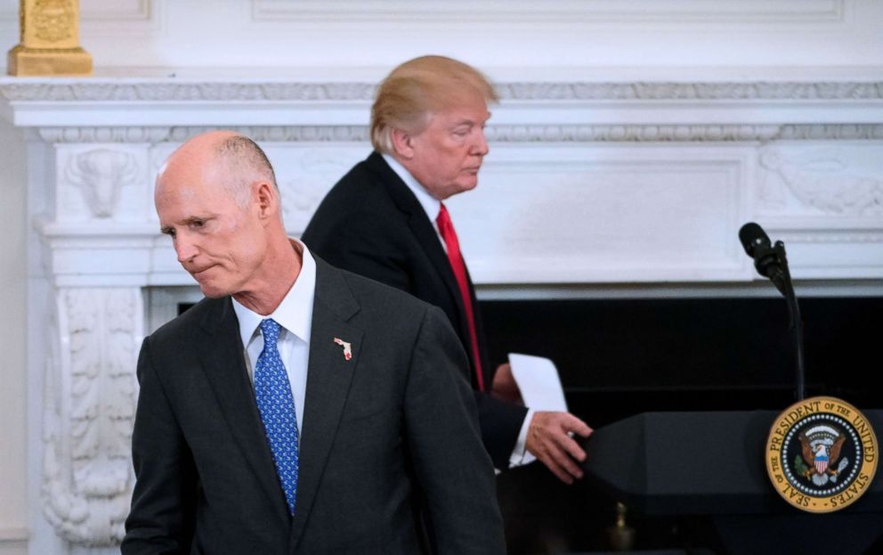 PHOTO: President Donald Trump returns to the lectern as Florida Governor Rick Scott returns to his seat after addressing the 2018 White House business session with governors in the State dining Room of the White House, Feb. 26, 2018.