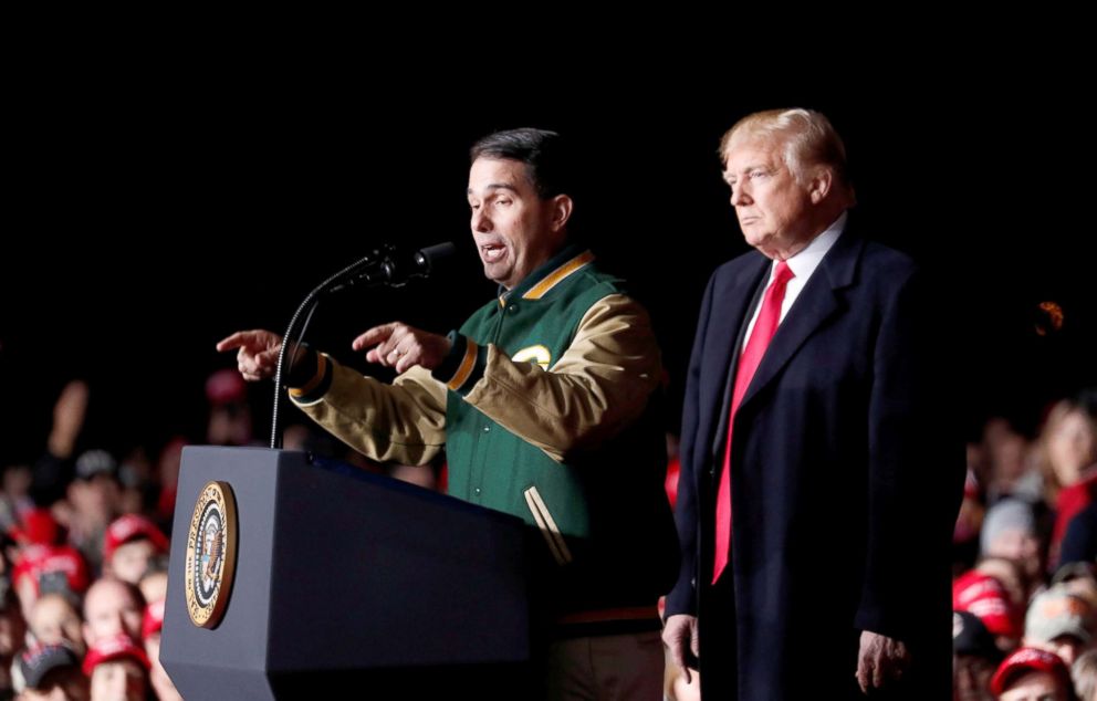 PHOTO: Governor Scott Walker speaks to the crowd as President Donald Trump looks on at a campaign rally in Mosinee, Wisconsin, Oct. 24, 2018.