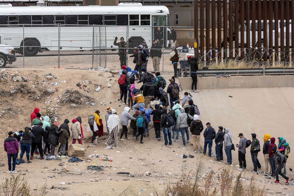 PHOTO: Immigrants seeking asylum turn themselves in to U.S. Border Patrol agents after wading across the Rio Grande to El Paso, Texas, Dec. 18, 2022 from Ciudad Juarez, Mexico.