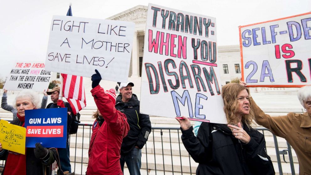 PHOTO: Advocates hold signs in front of the U.S. Supreme Court before the start of oral arguments in the Second Amendment case, Dec. 2, 2019, in Washington, D.C.