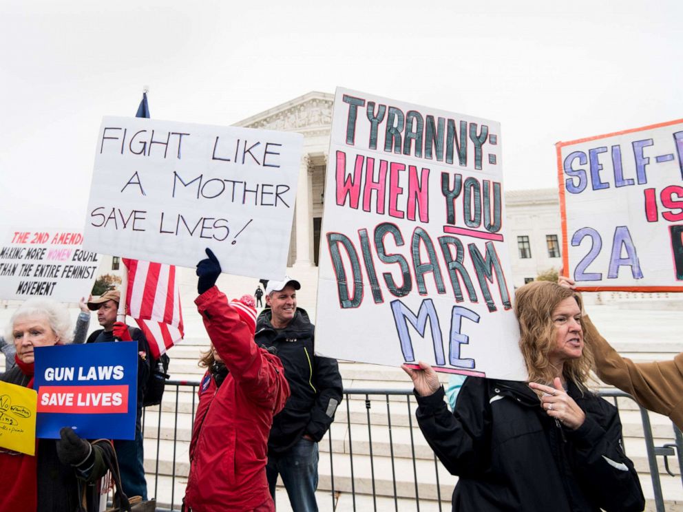 PHOTO: Advocates hold signs in front of the U.S. Supreme Court before the start of oral arguments in the Second Amendment case, Dec. 2, 2019, in Washington, D.C.