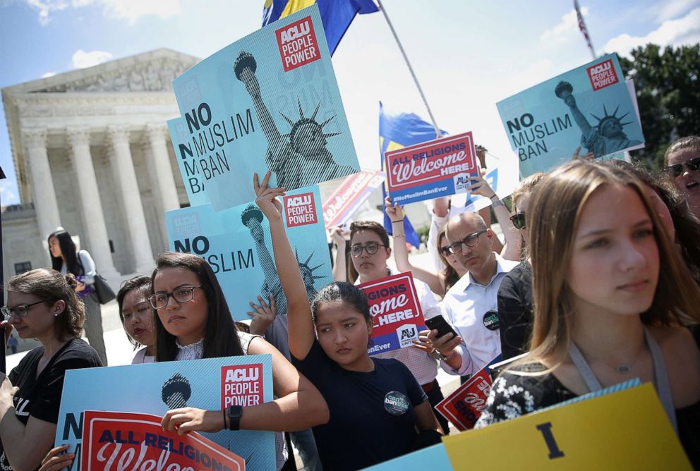 PHOTO: Protesters hold up signs that read 'No Muslim ban' against President Trump's travel ban outside the U.S. Supreme Court as the court issued an immigration ruling June 26, 2018 in Washington, D.C.