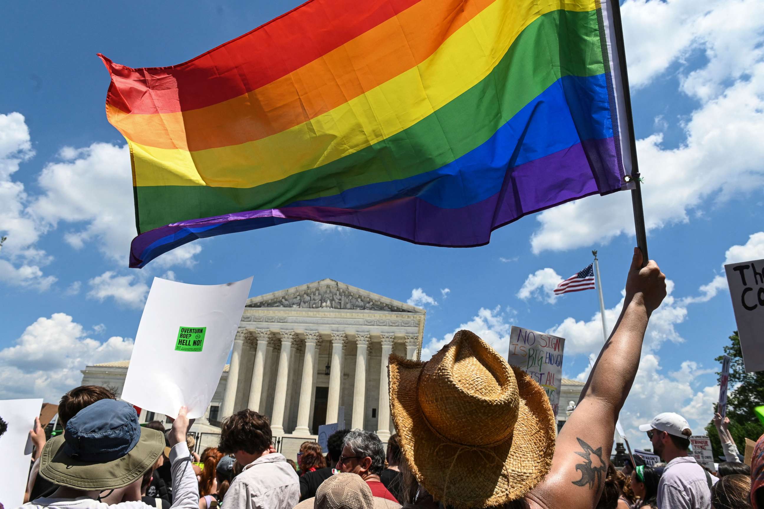 PHOTO: An abortion rights demonstrator waves a Pride flag during a rally in front of the US Supreme Court in Washington, DC, on June 25, 2022.