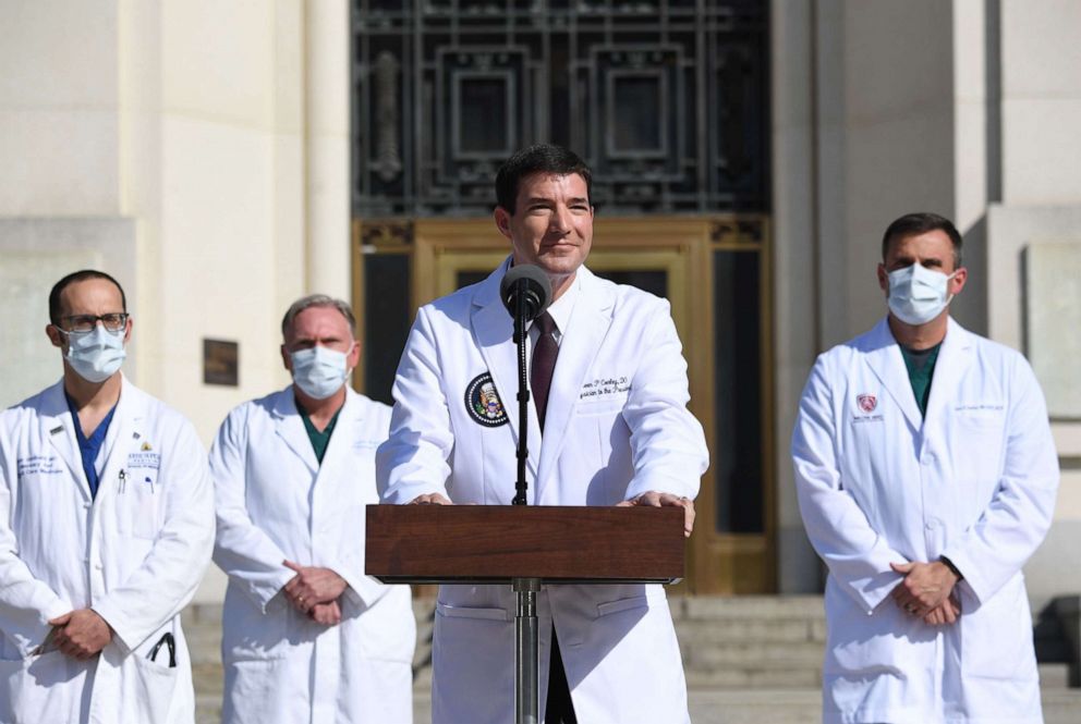 PHOTO: White House physician Sean Conley answers questions surrounded by other doctors, during an update on the condition of President Donald Trump, at Walter Reed Medical Center in Bethesda, Md.