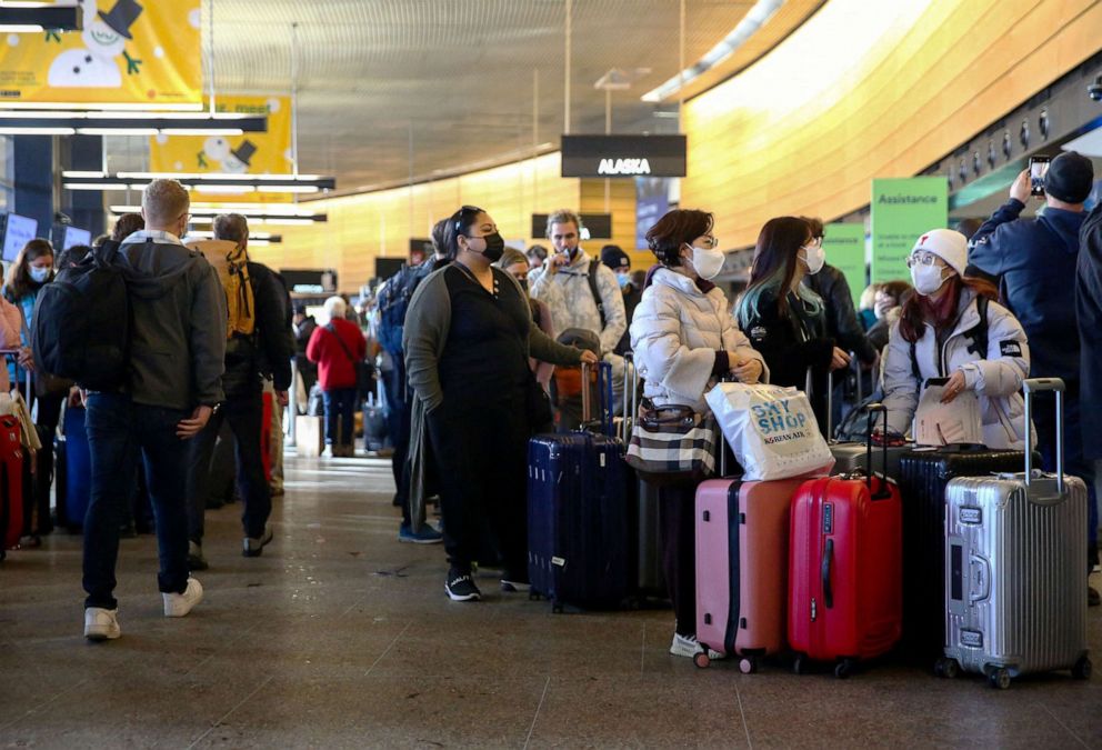 PHOTO: People queue in long ticketing and baggage lines after dozens of flights were listed as cancelled or delayed at Seattle-Tacoma International Airport (Sea-Tac) in Seattle, Dec. 27, 2021.