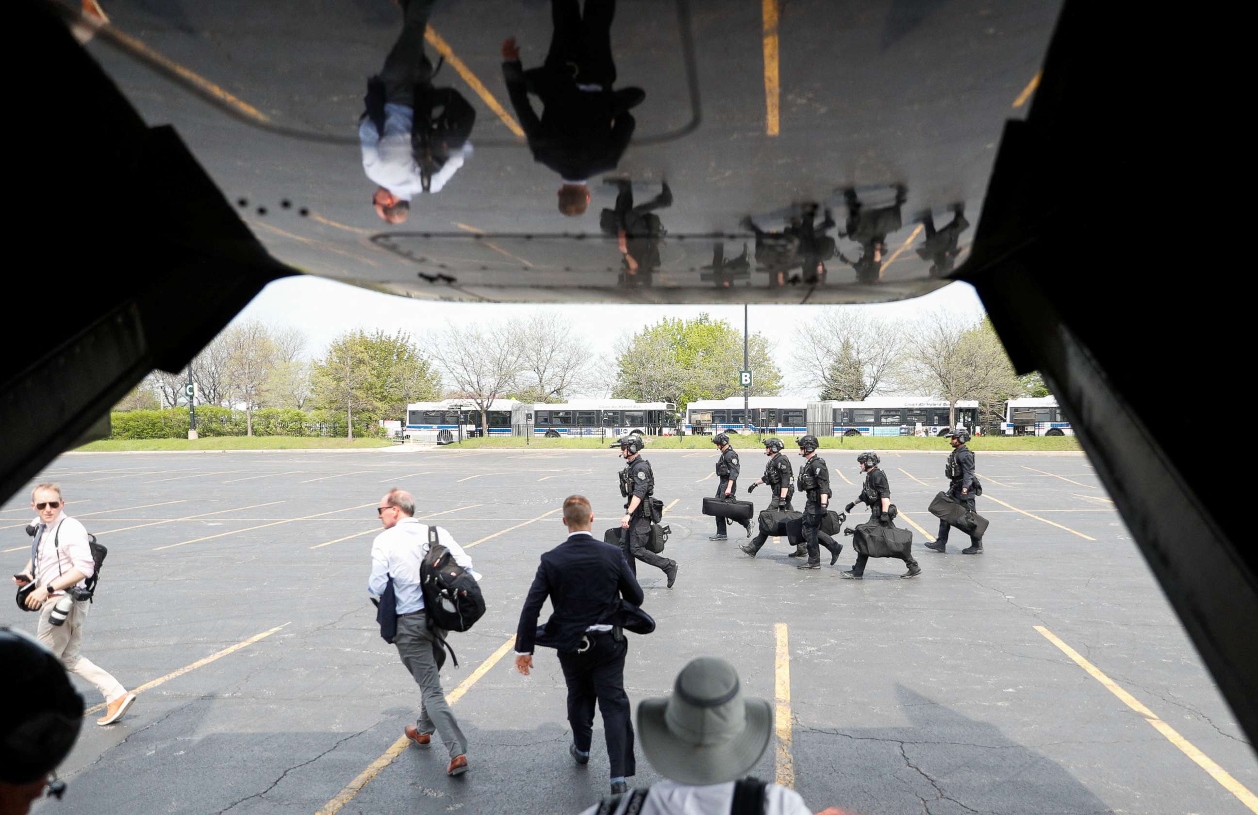 PHOTO: Members of Secret Service Counter Assault Team (CAT) walk on the tarmac as U.S. President Joe Biden lands aboard Marine One in Chicago, Illinois, U.S., May 11, 2022. 
