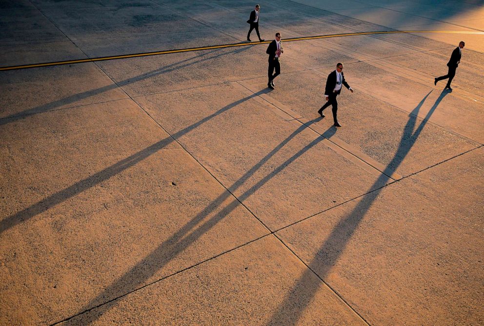 PHOTO: U.S. Secret Service officers walk across the tarmac at Andrews Air Force Base as President Donald Trump arrives to board Air Force One in George's County, Md., Nov. 1, 2019.