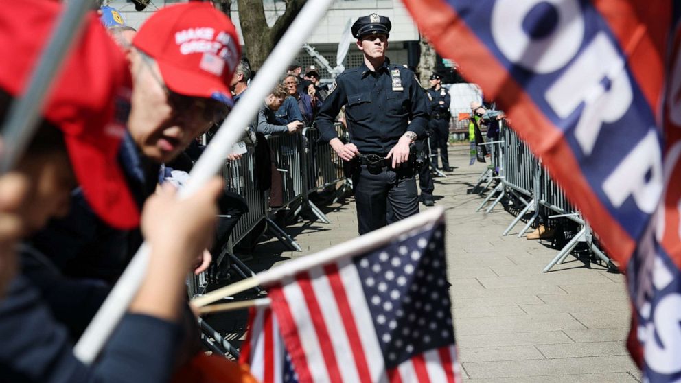 PHOTO: Police stand between supporters of former President Donald Trump and counter-protesters who are being kept apart outside of the Manhattan Criminal Court before his arraignment, April 4, 2023, in New York City.
