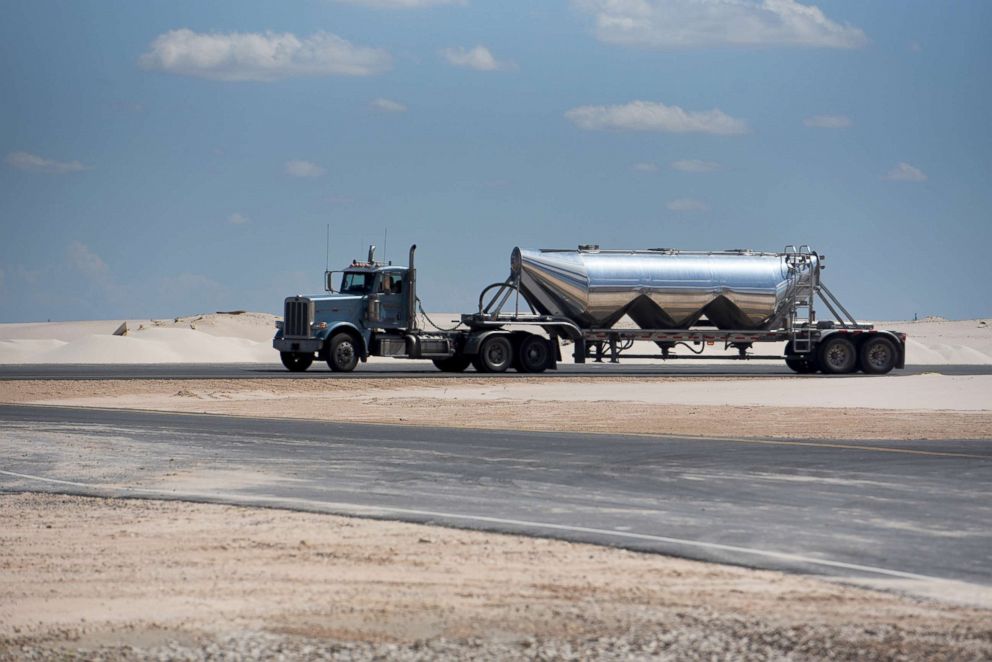 PHOTO: A semi truck filled with sand exits from the Black Mountain Sand LLC Vest Mine in Winkler County, Texas, June 19, 2018.