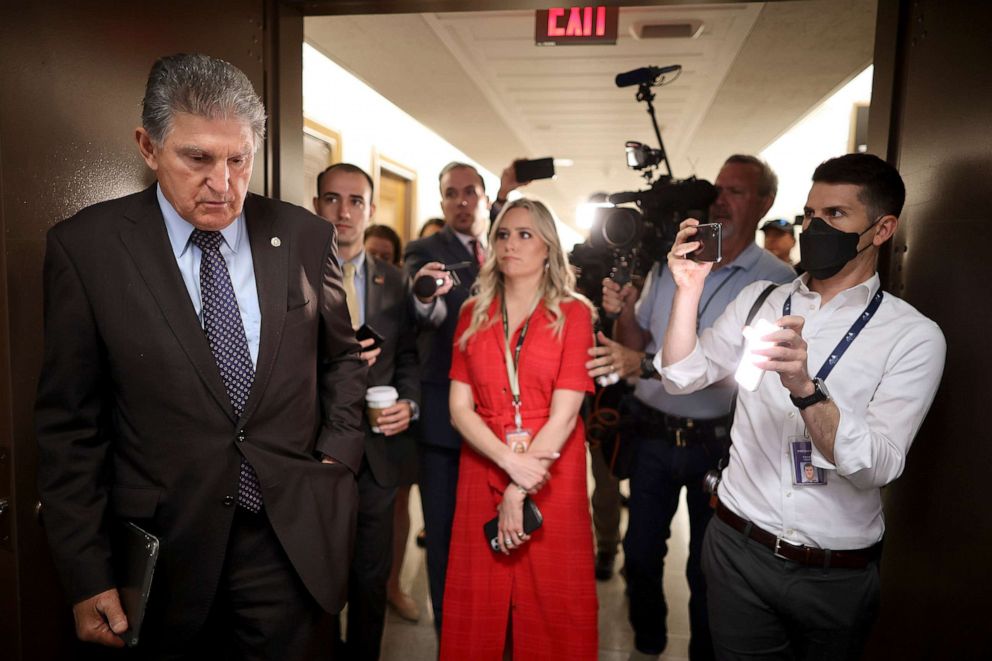 PHOTO: Sen. Joe Manchin talks to reporters about his support for a Jan. 6 commission while walking down the hall of the Dirksen Senate Office Building on May 27, 2021 in Washington, D.C.