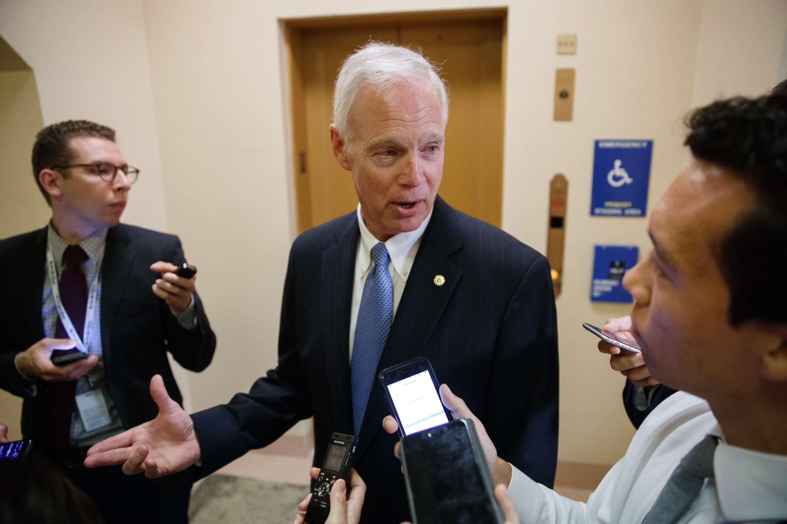 PHOTO: Sen. Ron Johnson, R-Wis. responds to reporters as he and other Senators arrive for weekly policy meetings on Capitol Hill in Washington, July 11, 2017. 