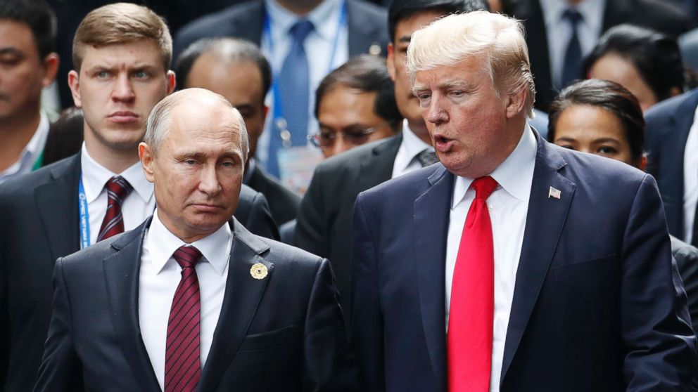 President Donald Trump and Russia's President Vladimir Putin talk during the family photo session at the APEC Summit in Danang, Vietnam, Nov. 11, 2017.