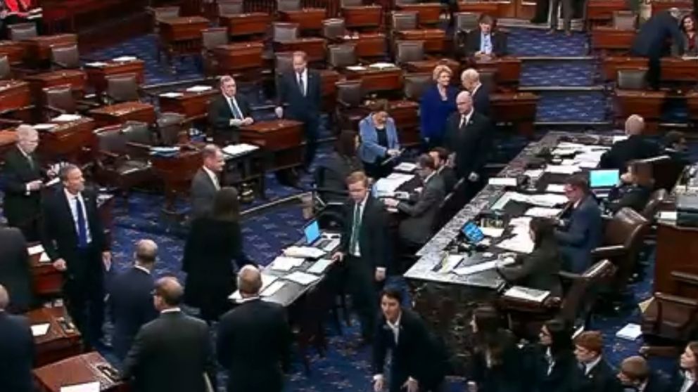 PHOTO: An image made from video shows politicians and staff on the floor of the U.S. Senate and the vote tally for terminating President Donald Trump's border emergency declaration, in Washington, March 14, 2019.