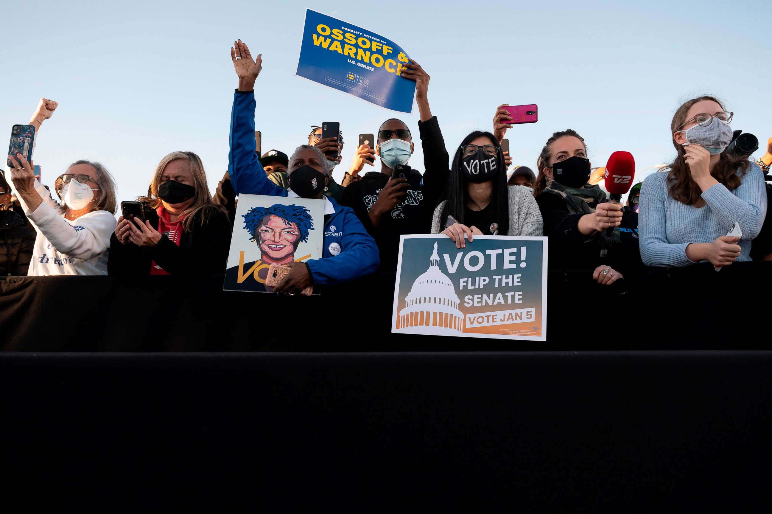 PHOTO: TOPSHOT - Supporters of democratic candidates for Senate Jon Ossoff and Raphael Warnock (listen to US President-elect Joe Biden speak during a rally outside Center Parc Stadium in Atlanta, Georgia, on January 4, 2021.