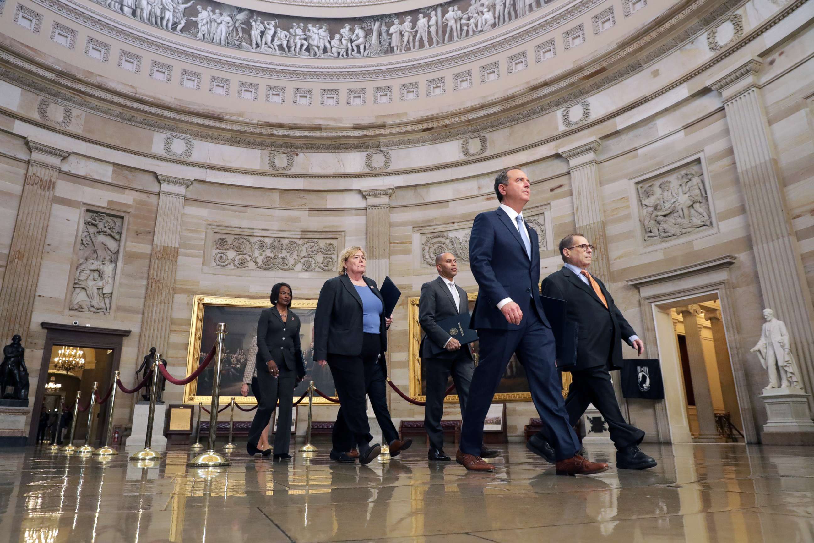 PHOTO: Representatives walk through the Rotunda of the Capitol on their way to the Senate, Jan. 16, 2020.