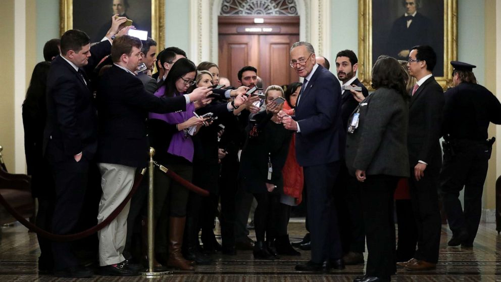 PHOTO: Senate Minority Leader Chuck Schumer talks to reporters who are restricted to a pen on the second floor of the U.S. Capitol during a break in the impeachment trial of President Donald Trump on Jan. 21, 2020 in Washington, D.C.