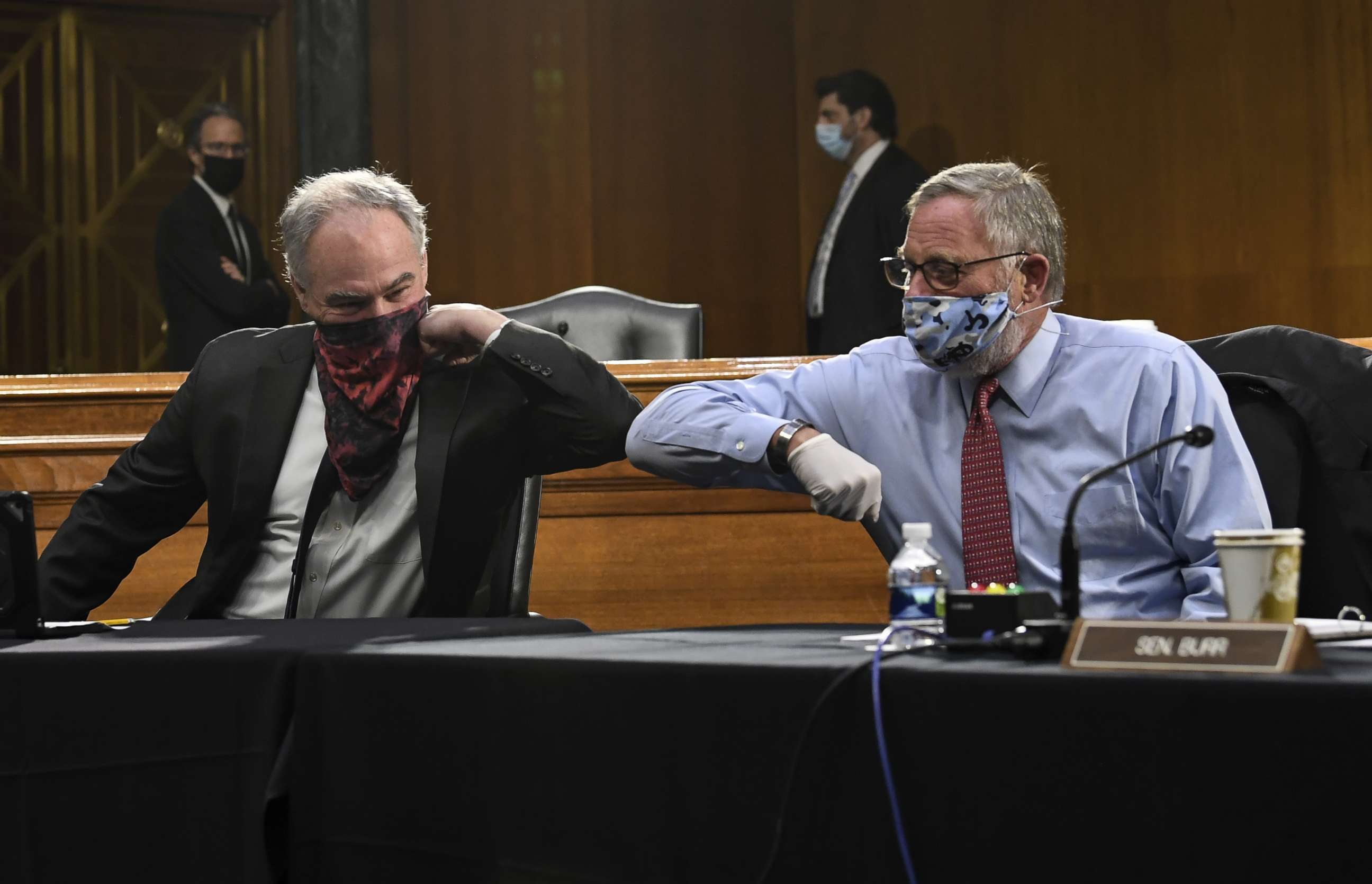 PHOTO: Senators Tim Kaine and Richard Burr greet each other with an elbow bump before the Senate Committee for Health, Education, Labor, and Pensions hearing on COVID-19, May 12, 2020, in Washington.