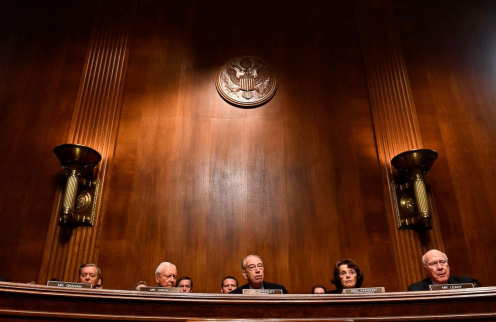 Judiciary Committee members Democratic Sen. Dianne Feinstein, 2nd right, GOP Chairman Charles Grassley, center, look on before a markup hearing on Capitol Hill in Washington, Sept. 28, 2018