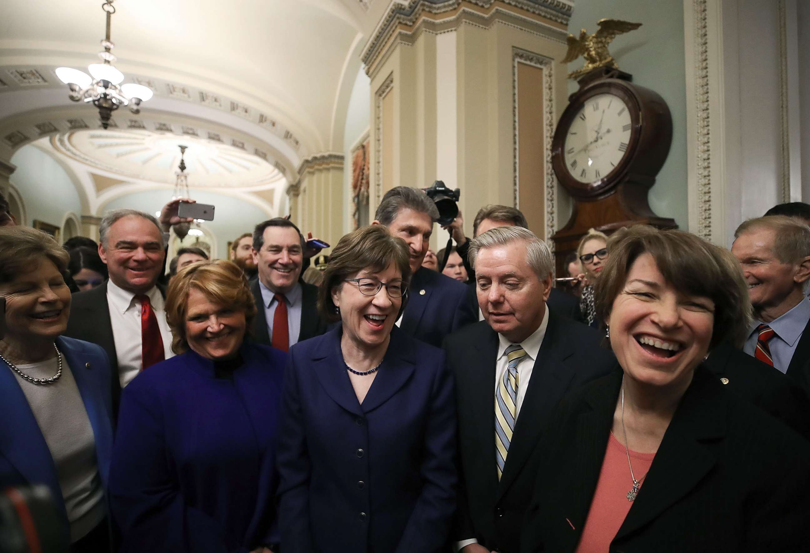 PHOTO: Sen. Susan Collins stands with Sen. Lindsey Graham and other fellow Senators after the Senate voted and passed a resolution to reopen the government, at the U.S. Capitol on Jan. 22, 2018 in Washington.
