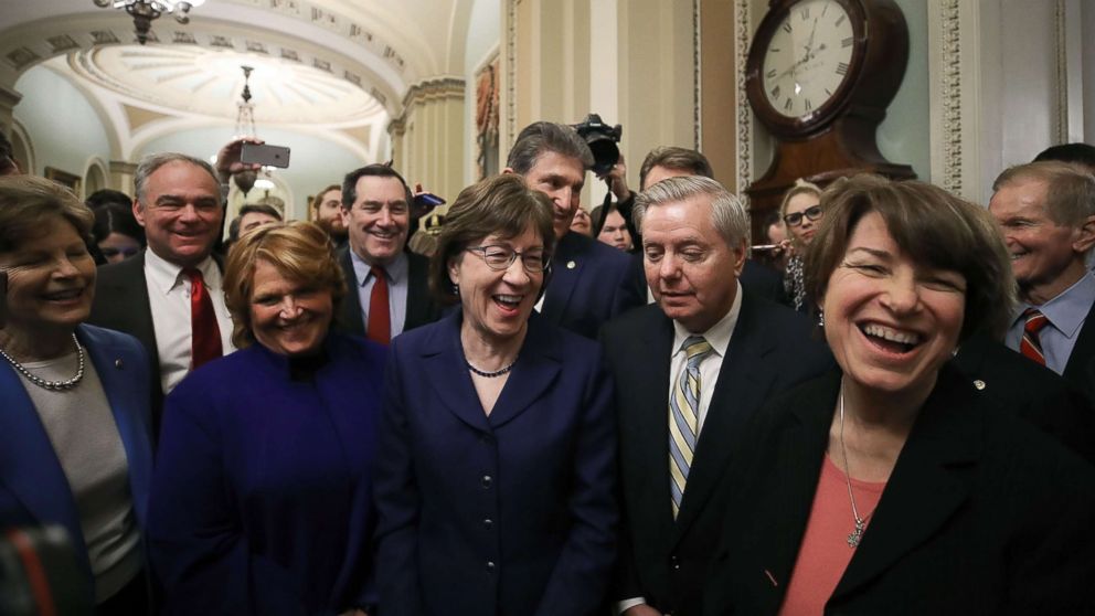 PHOTO: Sen. Susan Collins stands with Sen. Lindsey Graham and other fellow Senators after the Senate voted and passed a resolution to reopen the government, at the U.S. Capitol on Jan. 22, 2018 in Washington.