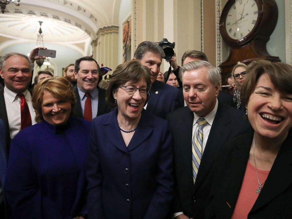 PHOTO: Sen. Susan Collins stands with Sen. Lindsey Graham and other fellow Senators after the Senate voted and passed a resolution to reopen the government, at the U.S. Capitol on Jan. 22, 2018 in Washington.